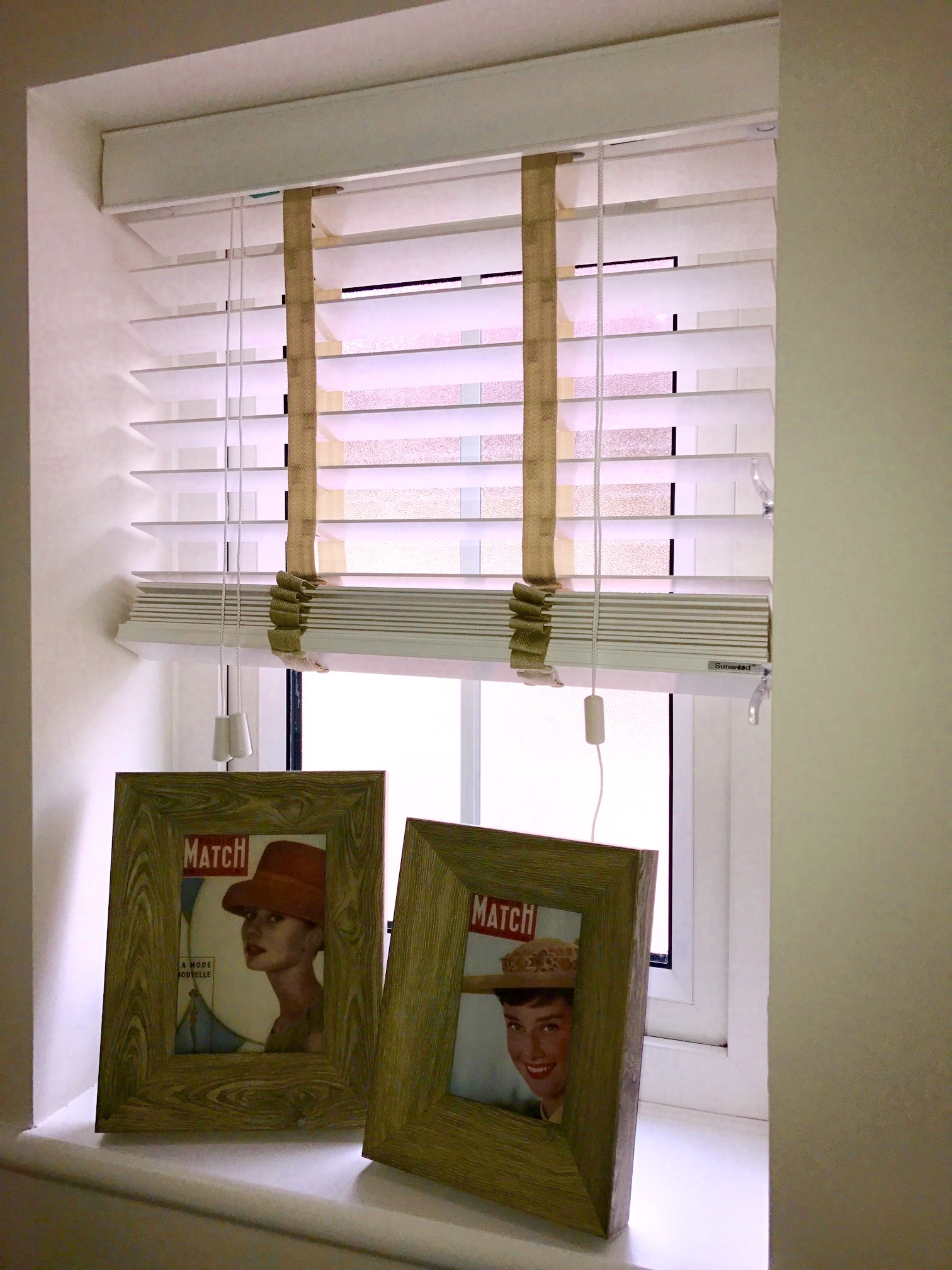 Two picture frames on a window sill