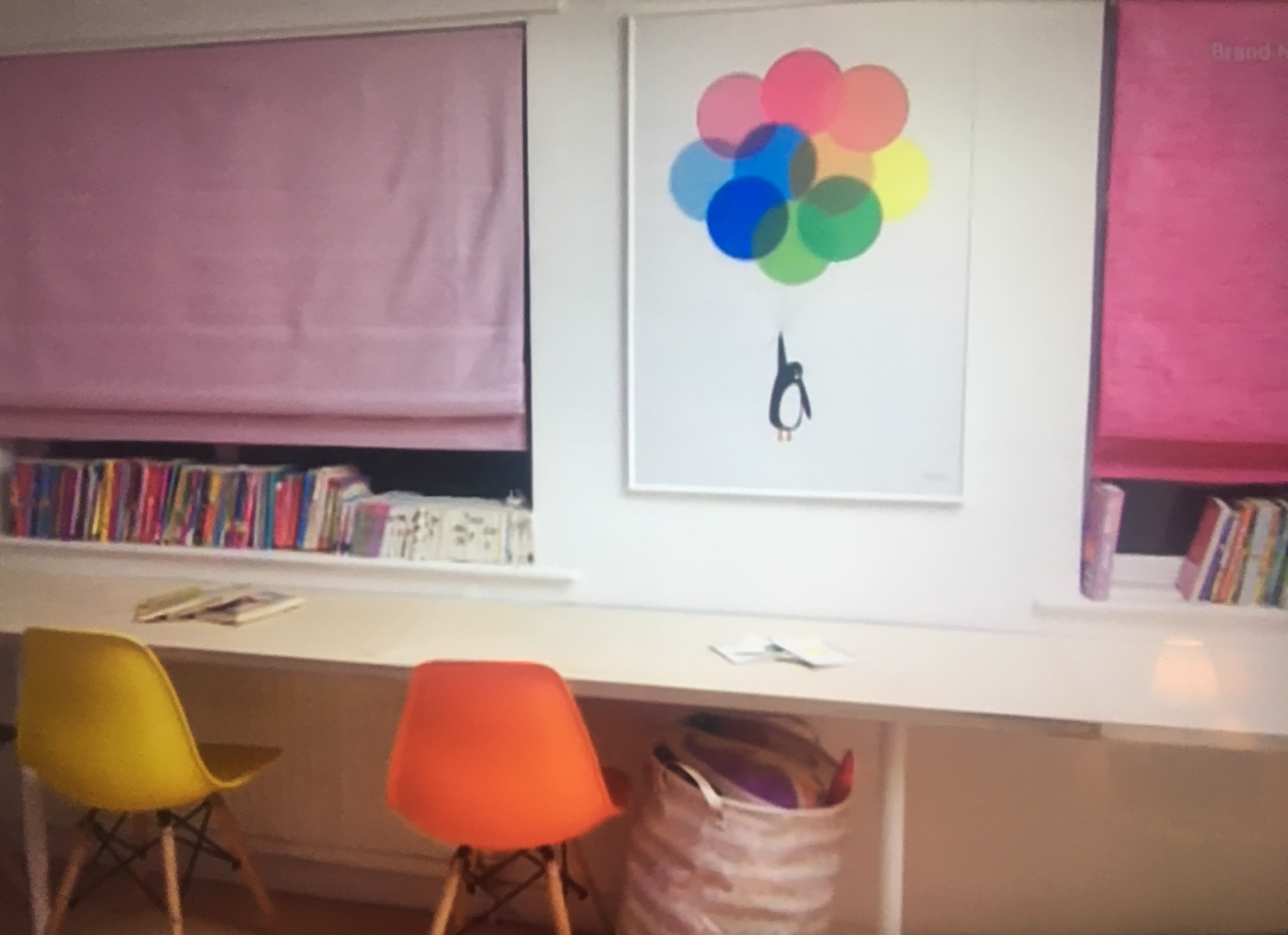 Childrens room with pink blinds and a painting