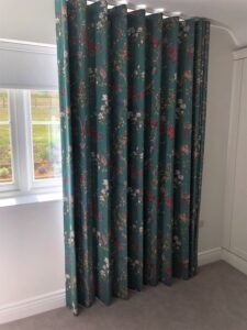 Wave Curtain in Japandi style printed fabric with a rich emerald green background and pink blossom flowers