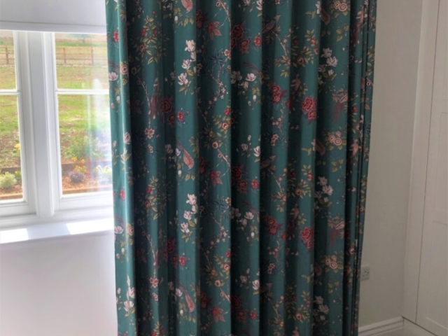 Wave Curtain in Japandi style printed fabric with a rich emerald green background and pink blossom flowers