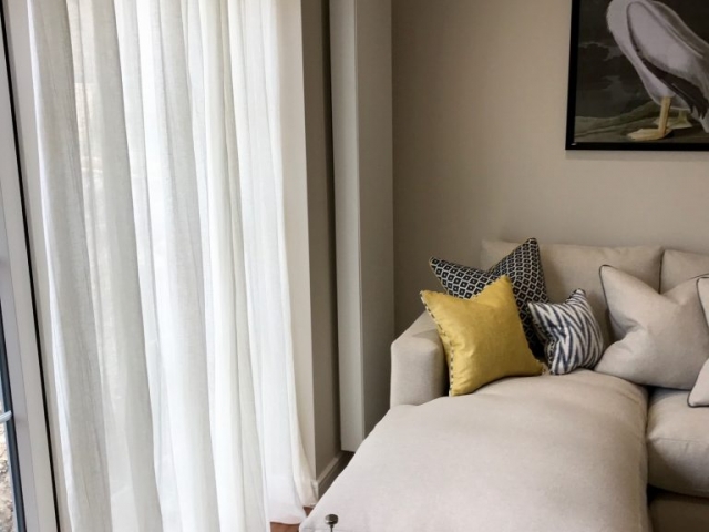 Voile Curtain next to a corner sofa in a living room