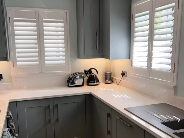 Fjord Blue Bespoke Kitchen with White Window Shutters made in the UK. Bespoke kitchen designed and installed in Brookmans Park