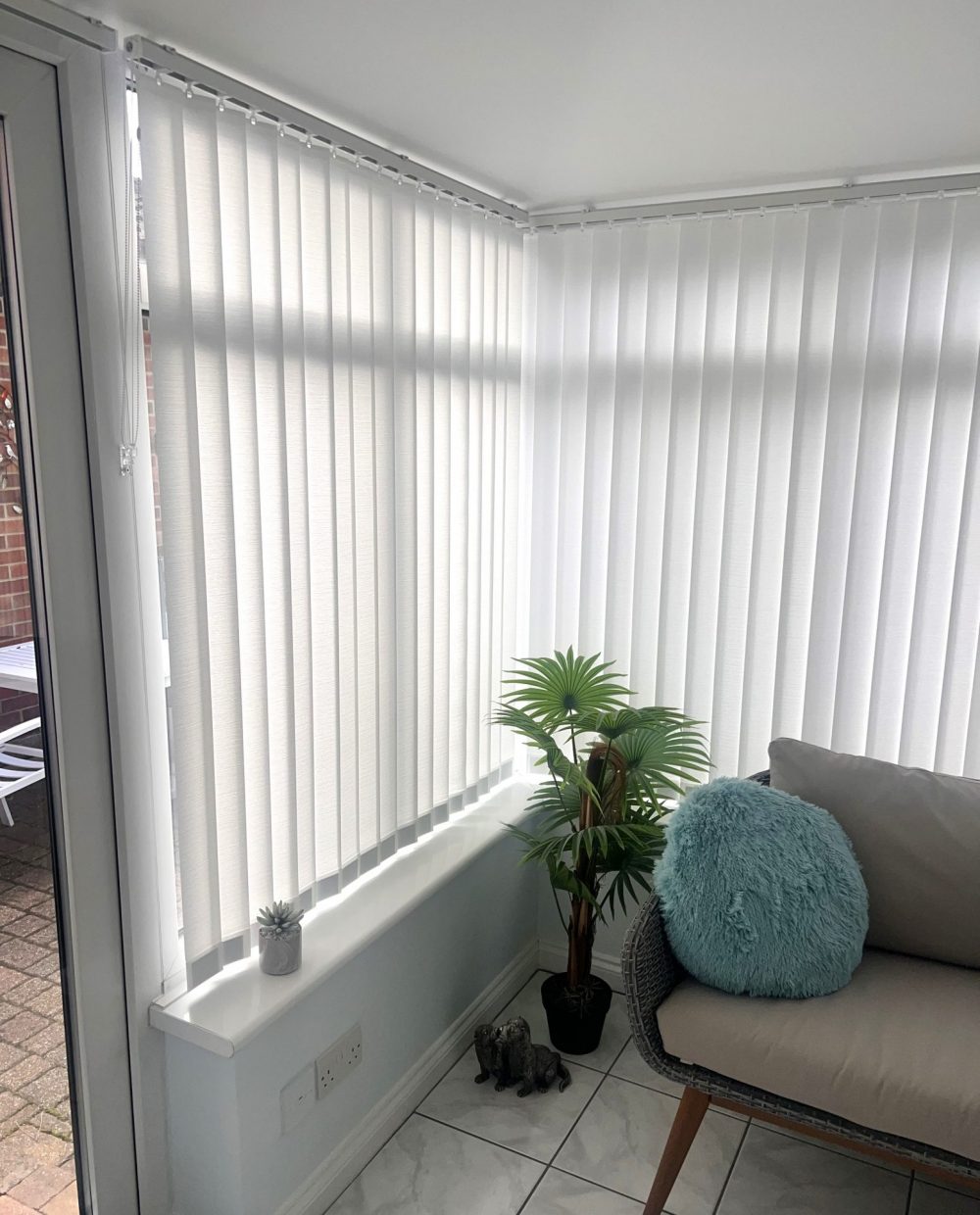 White textured fabric vertical blinds with sealed in bottom weights