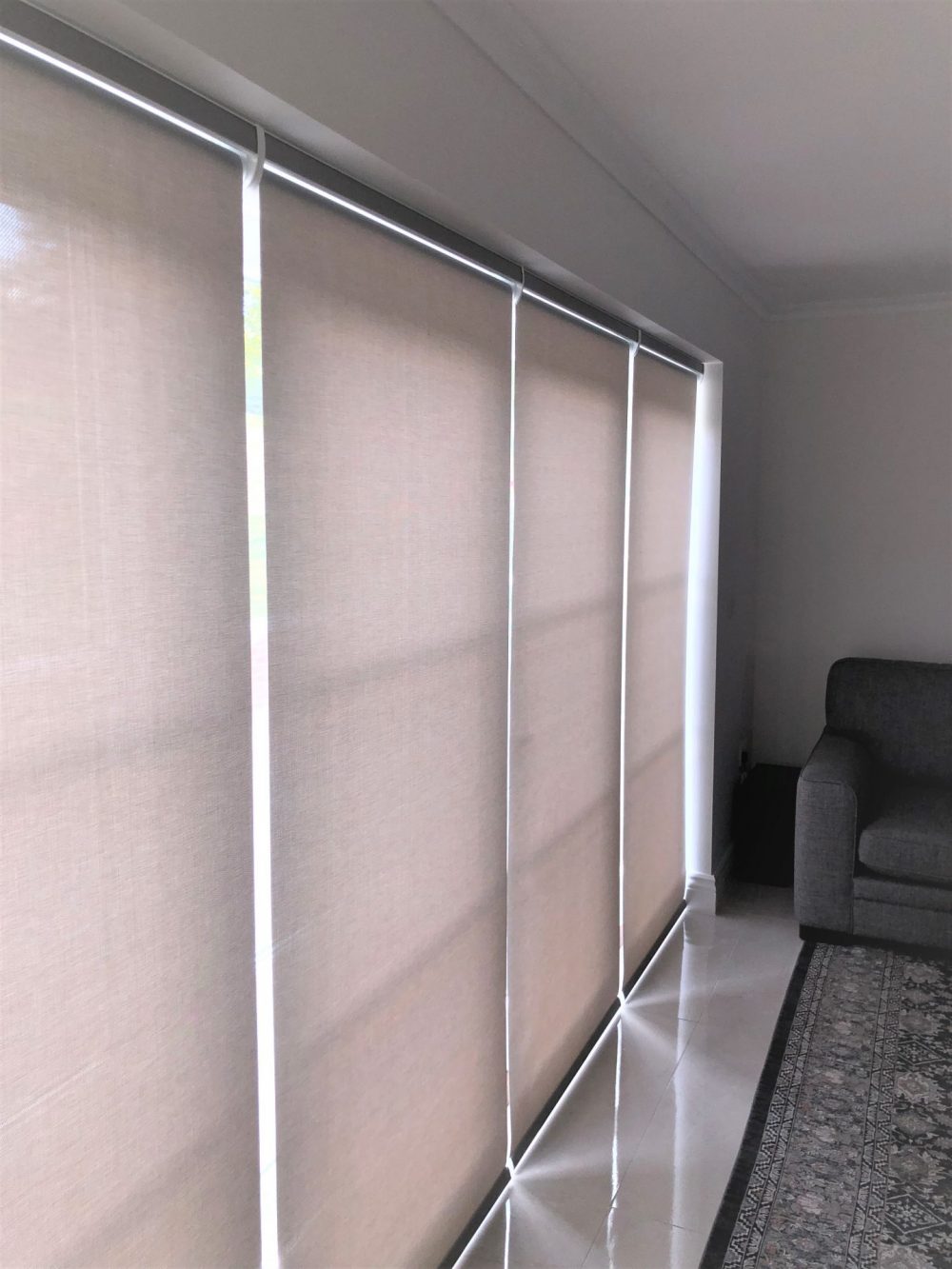 Screen Roller Blinds with fascia Headboxes and Rechargeable Motors Installed to Bifold Doors in Potters Bar