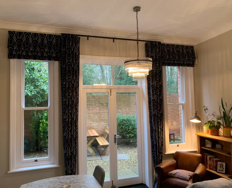 Roman blinds and 80mm wave curtains in Navy blue Art Deco patterned velvet fabric, with Matt Black wave track, fitted in Potters Bar