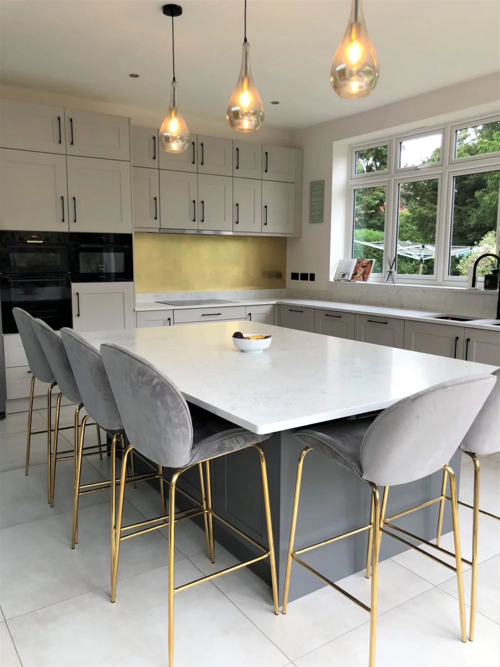 Bespoke kitchen in modern shaker style with quartz worktops, brass and black accents. Designed and installed in a period Hertford property