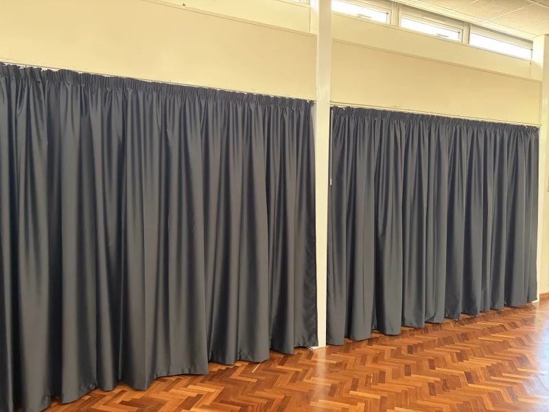 Pencil pleat flame-retardant dimout curtains in black fabric