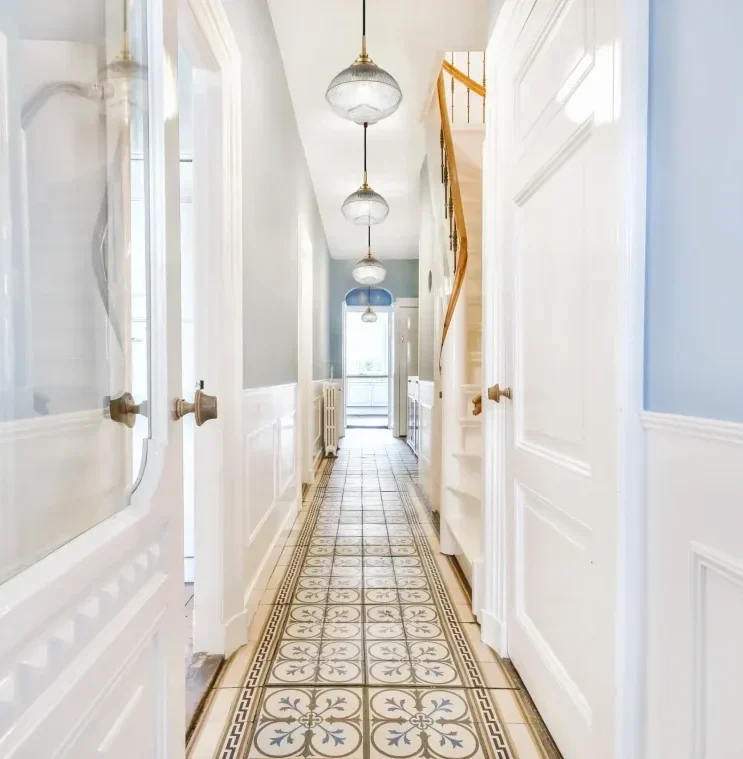 Acoste single pendant lights along a traditional tiled hallway