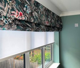 Roman blind in a tropical floral print velvet, with a voile roller blind inset behind for daytime privacy