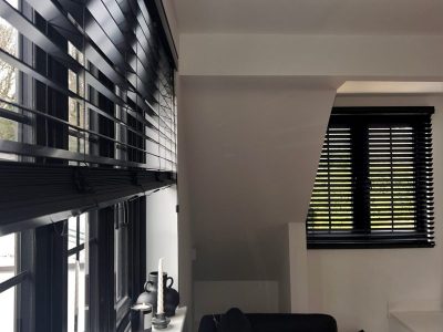 Black painted wood venetian blinds in a living room