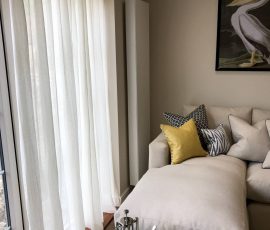 Pencil pleat voile curtain inset in patio door recess in a new build apartment