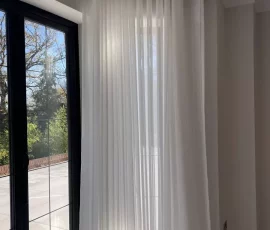 80mm Wave voile curtains installed in a bay window in Welwyn Garden City
