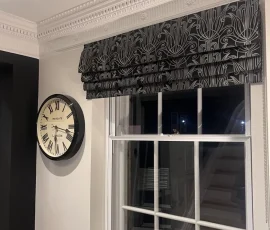 Roman blind in black art deco embroidered fabric fitted in the hallway of a period property in Hertford